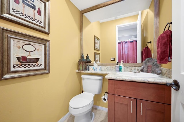 bathroom featuring toilet and vanity