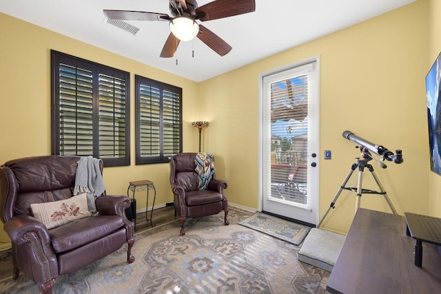 sitting room featuring ceiling fan