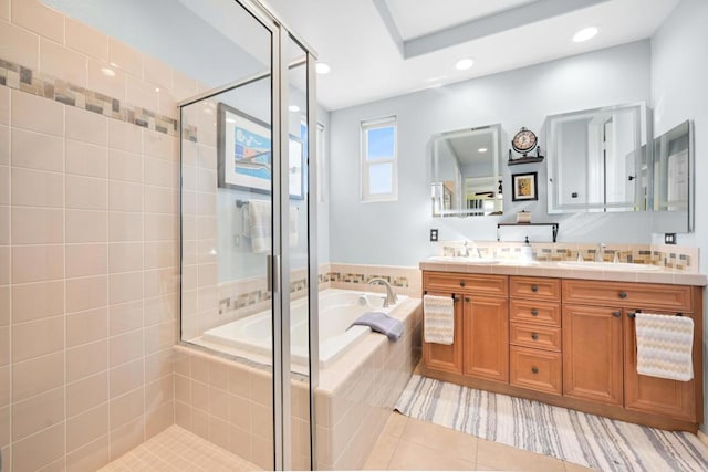 bathroom with tile patterned floors, vanity, and independent shower and bath