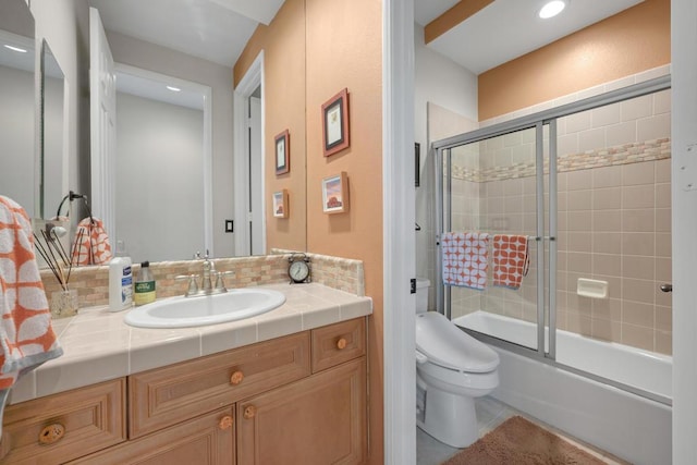 full bathroom featuring toilet, decorative backsplash, bath / shower combo with glass door, tile patterned floors, and vanity