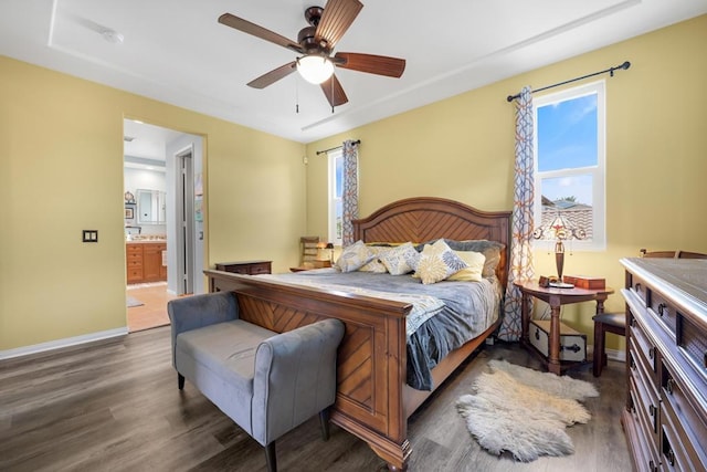 bedroom featuring ceiling fan, dark wood-type flooring, and ensuite bathroom