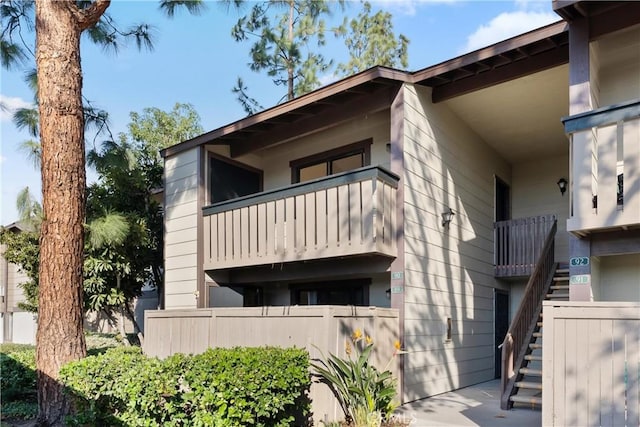 view of front of home featuring stairway and a balcony