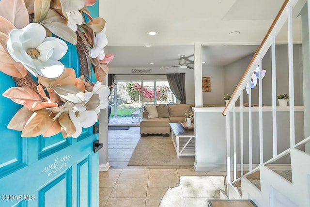 interior space with ceiling fan and light tile patterned flooring