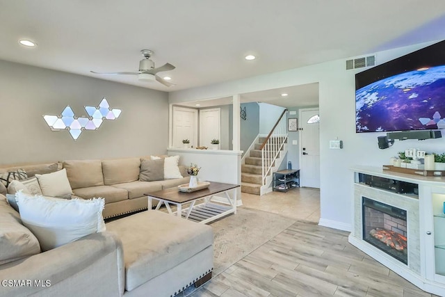 living room with light wood-type flooring and ceiling fan