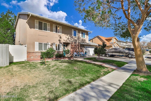 view of front of home with a front yard and a garage