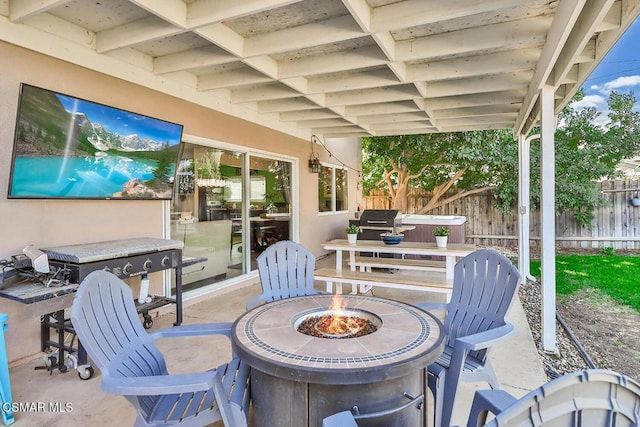 view of patio featuring an outdoor fire pit and a hot tub