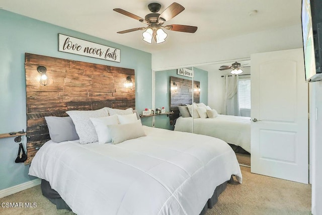 bedroom with ceiling fan and light colored carpet