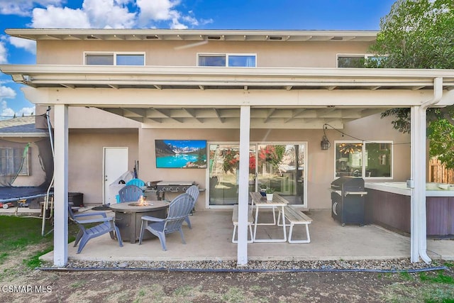 view of patio / terrace with an outdoor fire pit and area for grilling