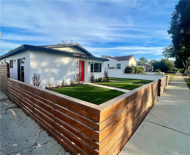 single story home featuring a front lawn