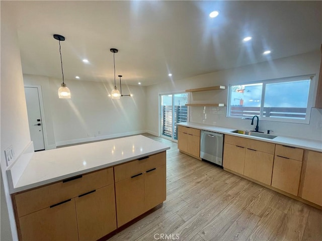 kitchen featuring decorative light fixtures, dishwasher, light hardwood / wood-style floors, sink, and light brown cabinetry