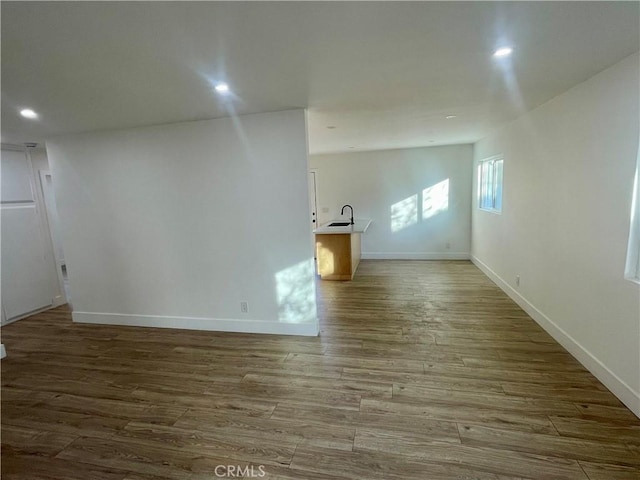 spare room featuring sink and hardwood / wood-style flooring