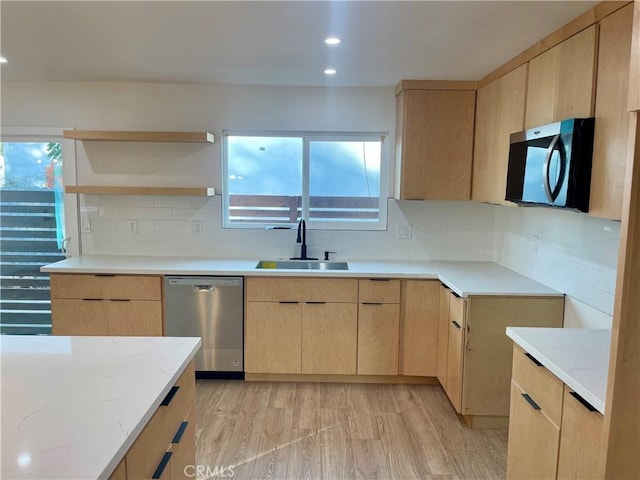 kitchen featuring backsplash, dishwasher, light hardwood / wood-style floors, sink, and light brown cabinetry