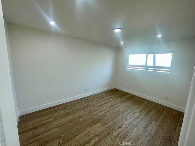 spare room with hardwood / wood-style floors