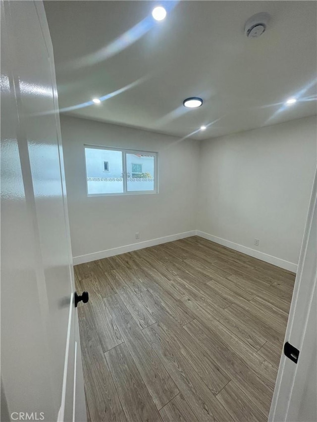 unfurnished room with light hardwood / wood-style floors