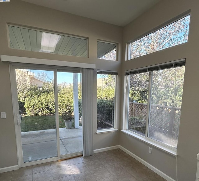 entryway with a healthy amount of sunlight and light tile patterned floors