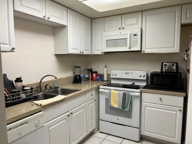 kitchen featuring white cabinetry, sink, white appliances, and light tile patterned flooring