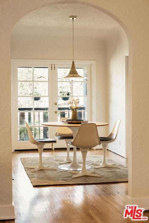 dining area featuring light wood-type flooring and french doors