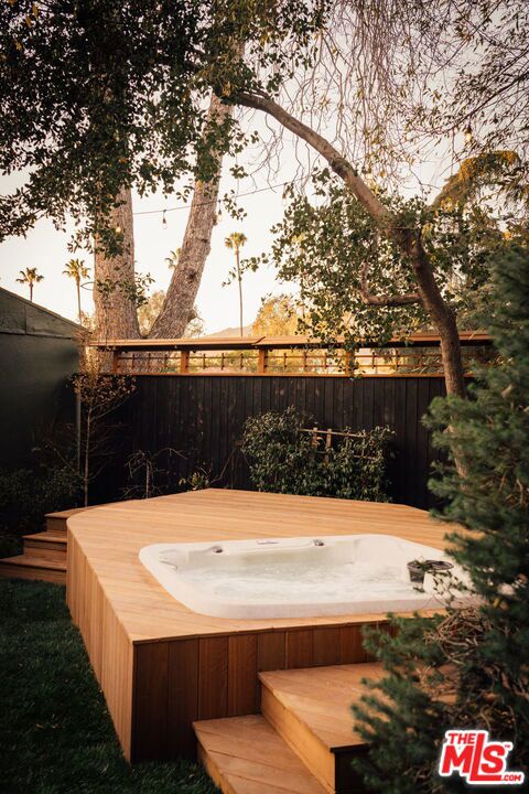 wooden terrace with a hot tub