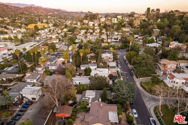 aerial view at dusk featuring a mountain view