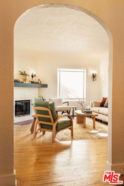 sitting room with hardwood / wood-style floors and a fireplace