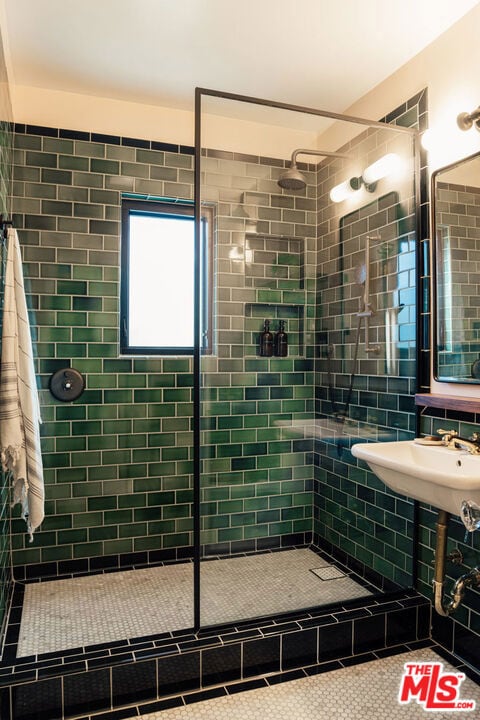 bathroom with tile patterned floors and a tile shower