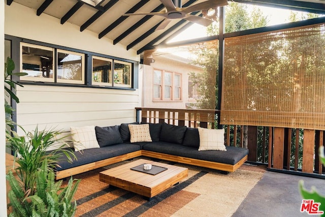 sunroom / solarium featuring ceiling fan and lofted ceiling with beams