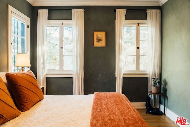 bedroom featuring wood-type flooring and ornamental molding