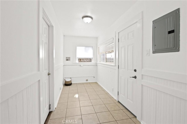 hallway with electric panel and light tile patterned flooring