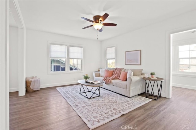 living room with ceiling fan, a healthy amount of sunlight, and hardwood / wood-style floors