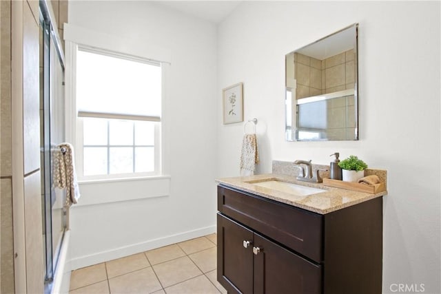 bathroom featuring vanity, tile patterned flooring, and a shower with door