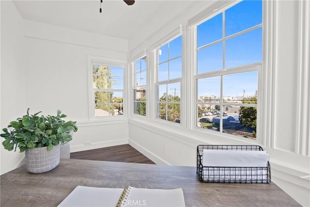 sunroom featuring ceiling fan