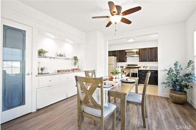 dining area featuring ceiling fan and light wood-type flooring