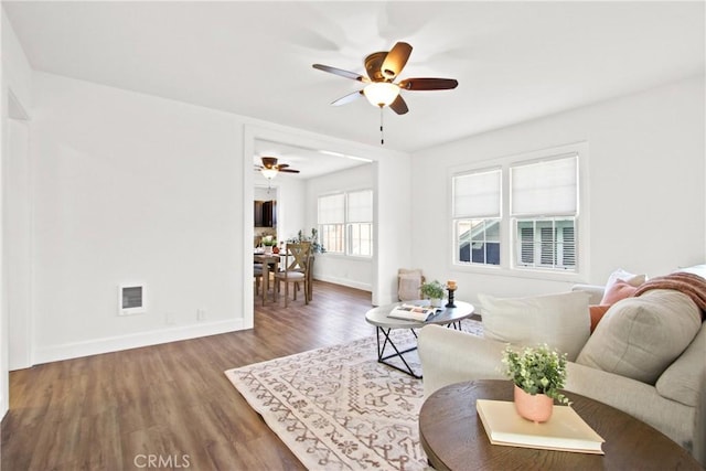 living room featuring hardwood / wood-style flooring and ceiling fan