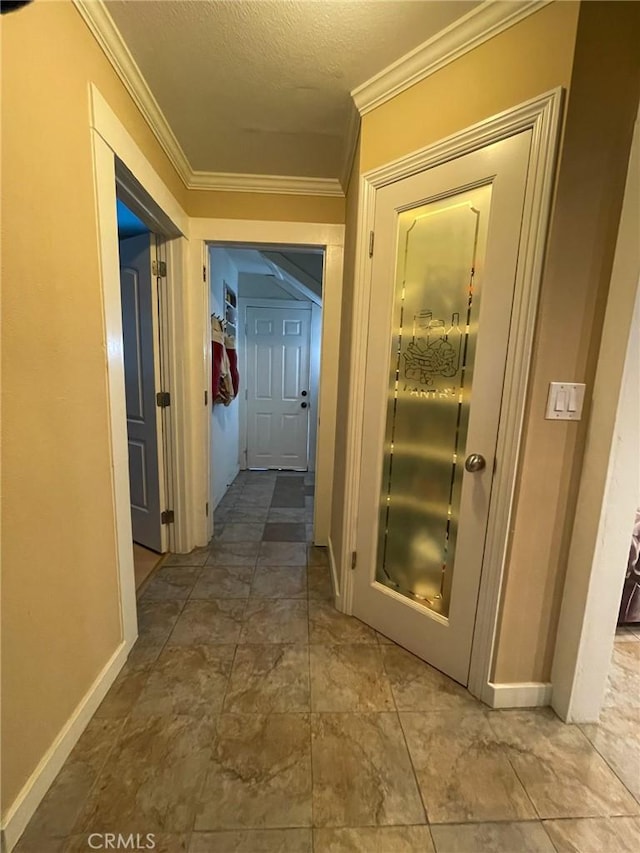 corridor with a textured ceiling and crown molding