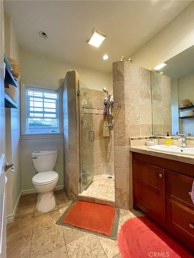 bathroom featuring toilet, walk in shower, and vanity