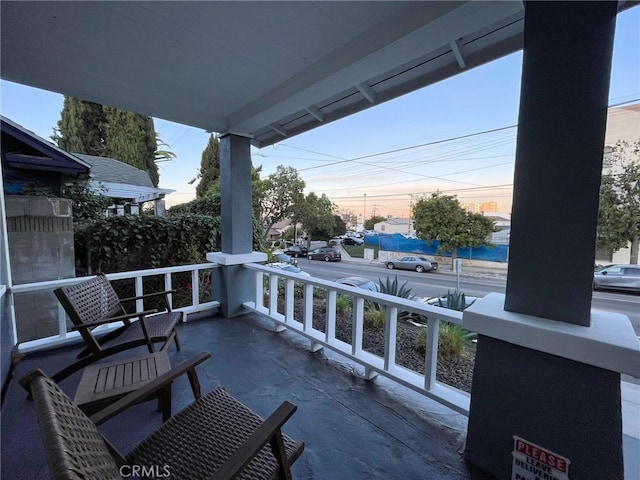 balcony at dusk with covered porch