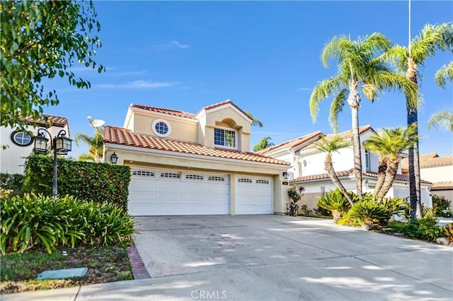 mediterranean / spanish home featuring a garage