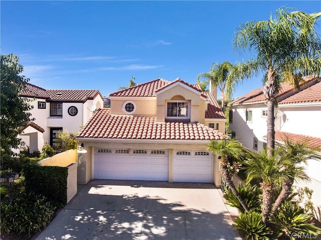 mediterranean / spanish house featuring a garage