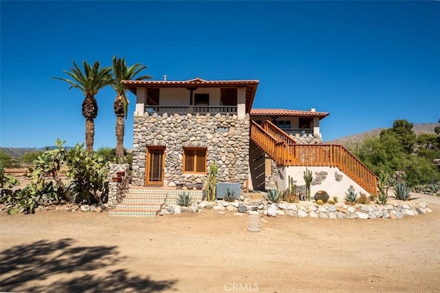 mediterranean / spanish-style house featuring a balcony