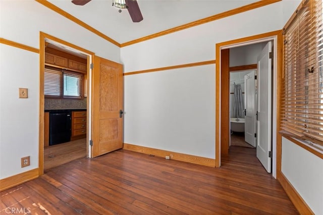 empty room featuring ceiling fan, dark hardwood / wood-style flooring, and crown molding