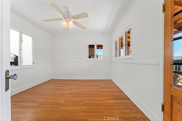 unfurnished room featuring light hardwood / wood-style floors, ornamental molding, and ceiling fan