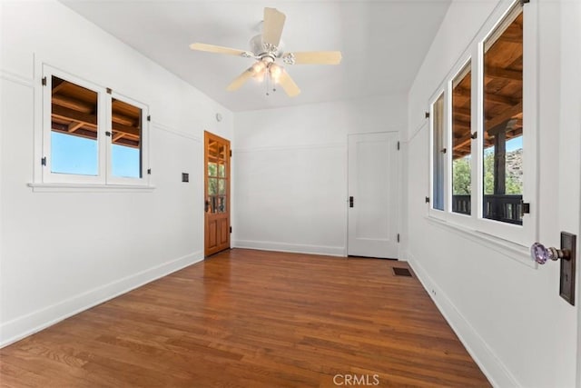 unfurnished room featuring ceiling fan, a healthy amount of sunlight, and wood-type flooring