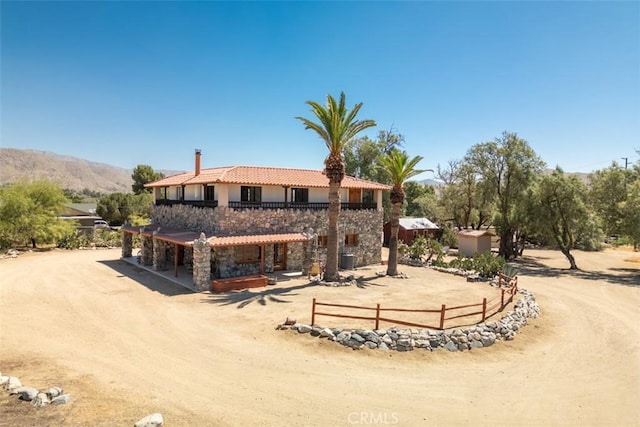 back of house with a mountain view