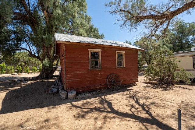 view of home's exterior featuring an outbuilding