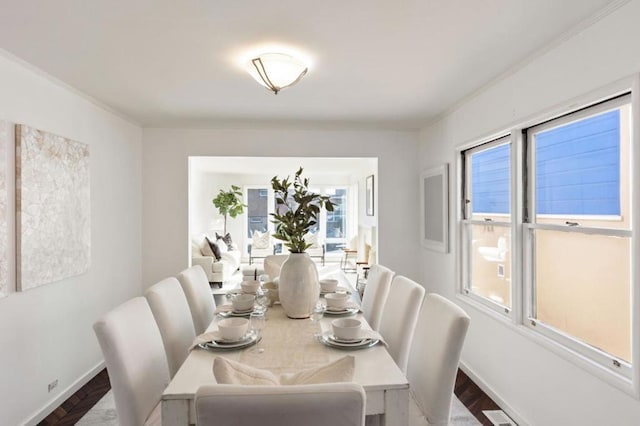 dining area featuring hardwood / wood-style flooring and ornamental molding