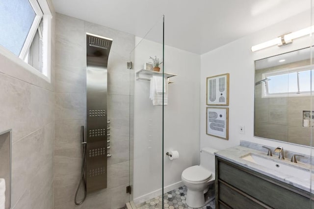 bathroom with an enclosed shower, vanity, and toilet