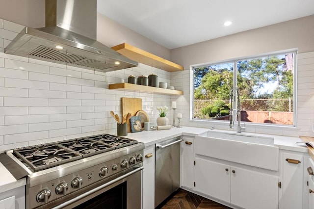 kitchen featuring tasteful backsplash, appliances with stainless steel finishes, island range hood, and white cabinetry