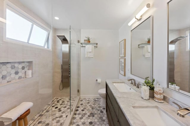 bathroom featuring toilet, vanity, and tiled shower