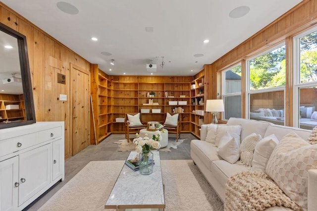 living room featuring wood walls and built in shelves