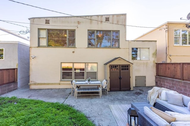 back of house featuring a patio area and outdoor lounge area